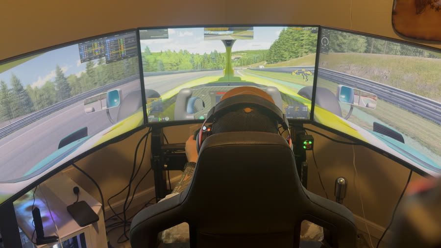 Triple monitor sim racing rig mid-lap